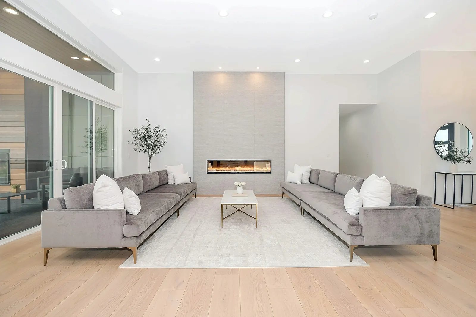 A bright modern living room with two sofas